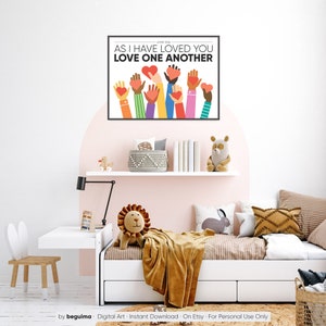 May include: A digital art print with a white background and colorful illustrations of hands holding hearts. The text "JOHN 15:34 AS I HAVE LOVED YOU LOVE ONE ANOTHER" is printed in black at the top of the print.