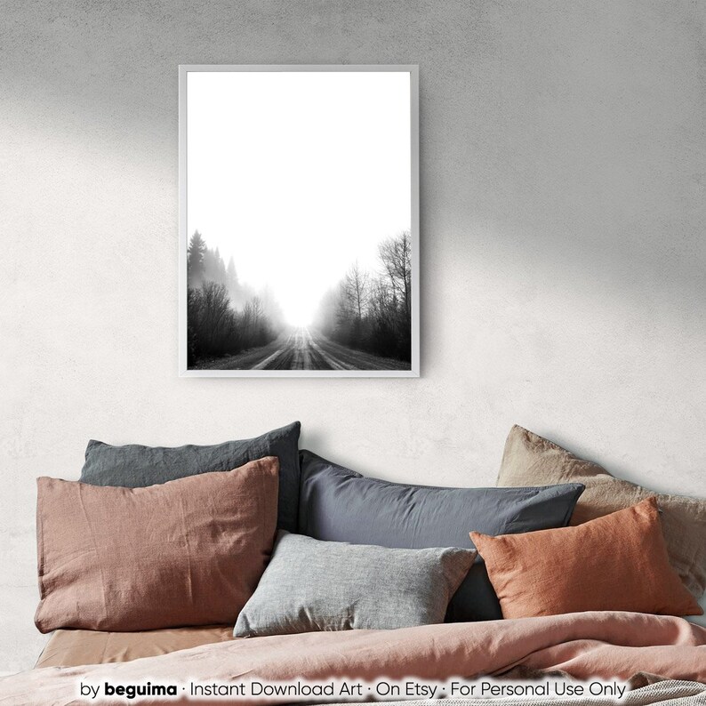 May include: Black and white framed print of a road disappearing into a foggy forest. The artwork is displayed above a bed with various colored pillows and a pink comforter. The print is labeled "Instant Download Art - On Etsy - For Personal Use Only".