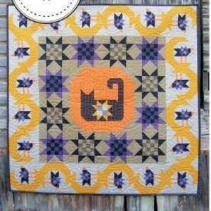 May include: A quilt pattern called "The Crow's Meow" with a cat design in the center. The quilt is 72 inches by 72 inches and features a yellow, orange, purple, and black color scheme.