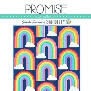 May include: A quilt pattern called "Promise" by Sarah Thomas of Sariditty. The pattern features a colorful rainbow design with clouds on a dark blue background. The finished size is 60 inches by 80 inches. The skill level is Confident Beginner and the technique is Foundation Paper Piecing.