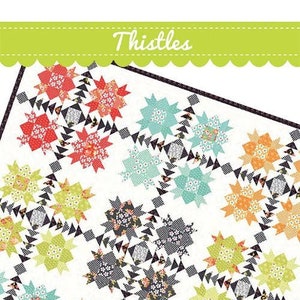 May include: A colorful quilt with a repeating floral pattern in shades of red, orange, green, and blue on a white background. The quilt features the word "Thistles" at the top and a label that says "Fat ¼ Friendly & no templates!"