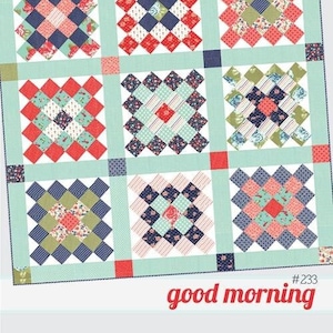 May include: A quilt pattern called "Thimble Blossoms" by Camille Roskelley. The pattern is fat quarter friendly and features a quilt block design with a mix of red, blue, green, and white fabrics. The quilt pattern is labeled "#233 good morning".