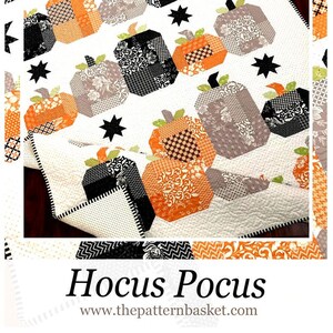 May include: A quilt pattern featuring a patchwork design of orange, black, and white pumpkins with black stars on a white background. The quilt pattern is titled "Hocus Pocus" and the website address "www.thepatternbasket.com" is displayed below the title.
