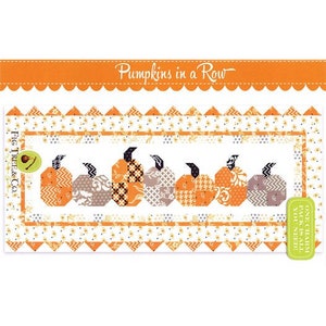 May include: A quilting pattern for a table runner featuring a row of pumpkins in various shades of orange, brown, and black. The pattern is called "Pumpkins in a Row" and is by Fig Tree & Co.