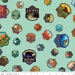 May include: A turquoise fabric with a repeating pattern of colorful national park patches. Each patch features a different park name, location, and a graphic image. The patches are in a variety of shapes and sizes.