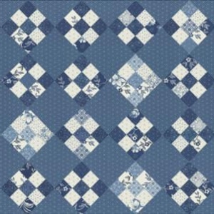 May include: A quilt with a diamond pattern in shades of blue and white. The quilt is made up of smaller squares with different floral patterns.