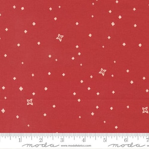 May include: Red fabric with a white diamond and star pattern. The fabric is marked with a ruler and the text "moda" appears twice.