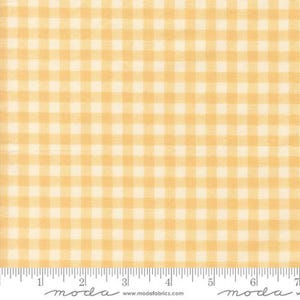 May include: A light yellow and white gingham fabric pattern featuring a repeating checkered design. A white ruler is visible at the bottom edge, showing measurements in inches from 1 to 7, with the text moda and www.modafabrics.com.