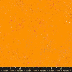 May include: Orange fabric with a speckled pattern of pink and gold. The fabric has a subtle texture and a slightly distressed look.