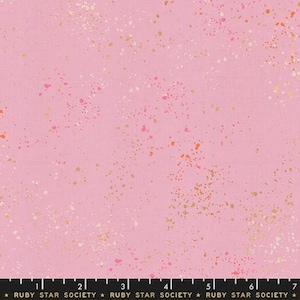 May include: Pink fabric with a speckled design. The fabric features a light pink background with scattered spots of gold, white, orange, and pink. The bottom of the image has a black ruler with the text "RUBY STAR SOCIETY".