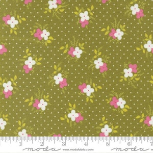 May include: Green fabric with a white and pink floral pattern and white polka dots. The fabric is 7 inches wide.