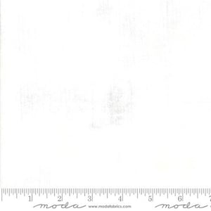 May include: White fabric with a subtle texture. The fabric is a solid white color and has a slightly rough feel. The fabric is shown with a ruler for scale.