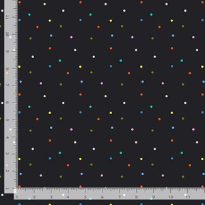 May include: A black fabric featuring a scattered pattern of small, multi-colored polka dots in shades of orange, blue, yellow, pink, teal, and white. A ruler along the left and bottom edges shows measurements in inches for scale reference.