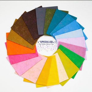 May include: A collection of 16 fabric squares in various colors with a speckled pattern. The fabric squares are arranged in a circle with the text "SPECKLED... by Rashida Coleman-Hale" in the center.