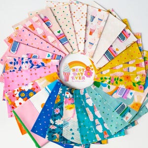 May include: A colorful fabric bundle arranged in a circular pattern. The fabrics feature various patterns, including ice cream cones, typewriters, hearts, and floral designs. A central button reads "Best Day Ever" with a rainbow and ice cream cone illustration.