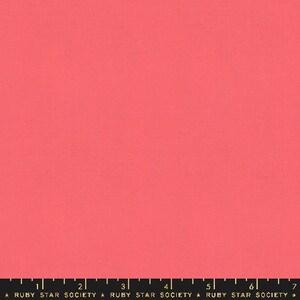May include: Solid coral pink fabric swatch. The fabric is smooth and has a subtle texture. The swatch is approximately 6 inches wide and 7 inches long.