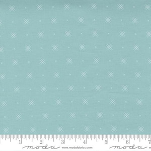 May include: A light blue fabric with a white crosshatch pattern. The fabric is shown with a ruler for scale.