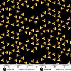 May include: Black fabric with a repeating pattern of gold triangles. The fabric is marked with a ruler in inches.
