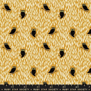 May include: A yellow fabric with a white pattern of feathers and black owls. The owls are facing forward with their wings spread out. The fabric is a repeating pattern.