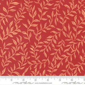 May include: Red fabric with a repeating pattern of light orange stylized leaves and vines. The leaves are arranged in a diagonal pattern across the fabric. The fabric has a textured appearance.