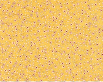 May include: Yellow fabric with a repeating floral pattern. Tiny white flowers with red centers and green stems are scattered across the fabric. The fabric is measured in inches along the bottom edge.
