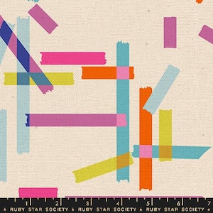 May include: A fabric with a cream-colored background featuring a colorful, abstract design. The design includes overlapping rectangles and lines in shades of pink, orange, blue, and yellow. The text "RUBY STAR SOCIETY" is at the bottom.
