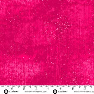 May include: A bright pink fabric with a white speckled pattern. The fabric has a textured, brushed look. The fabric is marked with "Andover" and "www.andoverfabrics.com".