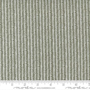 May include: A close-up of a fabric with a repeating pattern of small white arrows on a light brown background. The fabric is textured and has a subtle sheen.