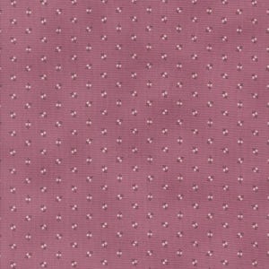 May include: A close-up of a dusty rose fabric with a repeating pattern of small white floral clusters and tiny dark gray stems. The fabric has a slightly textured appearance, suggesting a woven material.