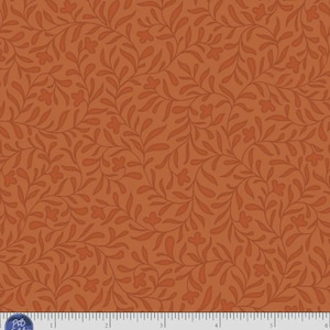 May include: A fabric swatch featuring a repeating pattern of dark orange leaves and small flowers on a medium orange background. The bottom edge displays a white ruler with markings in inches, the text P&B Textiles, and the code CMIL 6222 O.