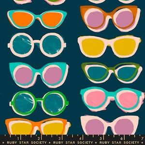 May include: A pattern of colorful sunglasses in various shapes and styles, including round, cat-eye, and square frames. The sunglasses feature a variety of colors, such as orange, yellow, pink, and teal, set against a dark blue background. The text "RUBY STAR SOCIETY" is at the bottom.