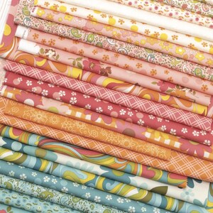 May include: A stack of fabric swatches in a variety of floral and paisley patterns. The fabrics feature a range of colors, including pink, orange, yellow, and blue. The swatches are neatly arranged, showcasing the different designs and textures.