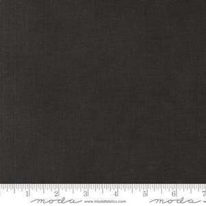 May include: Solid black fabric with a subtle woven texture. The fabric is a dark charcoal color, and a ruler is at the bottom of the image. The fabric is suitable for quilting, apparel, and home decor projects.