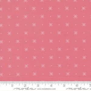 May include: Pink fabric with a white cross stitch pattern. The fabric has a subtle texture and is perfect for quilting or other craft projects.