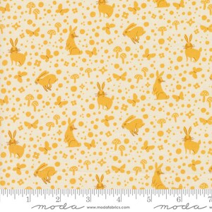 May include: A cream-colored fabric with a repeating pattern of yellow rabbits, butterflies, mushrooms, and floral shapes. The design includes various sizes of yellow dots. A ruler is at the bottom of the image, with measurements in inches.