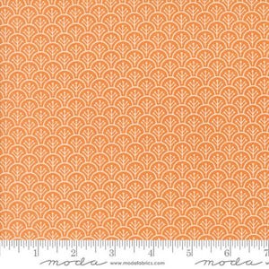 May include: Orange fabric with a repeating white fan-like pattern. The fabric has a ruler along the bottom edge, with measurements in inches. The fabric is from Moda Fabrics.