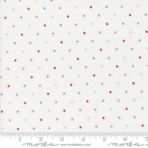 May include: White fabric with a scattered pattern of small red, blue, and gray dots. The fabric is marked with a ruler and the words "moda" and "www.modafabrics.com".