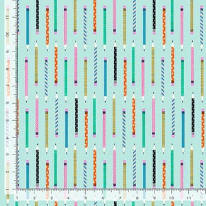 May include: A light blue fabric featuring a repeating pattern of vertical pencils in various colors and designs, including stripes, polka dots, and stars. A white ruler with inch markings is visible along the left and bottom edges of the image.