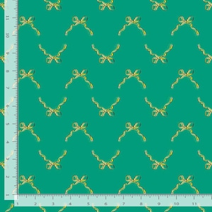 May include: A repeating pattern of yellow bows with flowing ribbons on a teal background. The bows are evenly spaced across the fabric, creating a decorative and festive design. The fabric is likely used for crafting or gift wrapping.