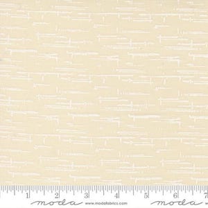 May include: A light cream-colored fabric featuring a repeating pattern of thin, horizontal white dashed lines and small vertical marks. A white ruler is visible at the bottom edge, showing measurements in inches from 0 to 7 inches.
