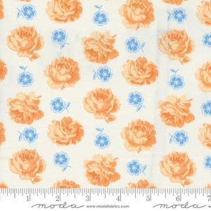May include: Cream-colored fabric with a repeating pattern of orange roses and small blue floral accents. The fabric has a ruler along the bottom edge with the word "moda" printed on it.