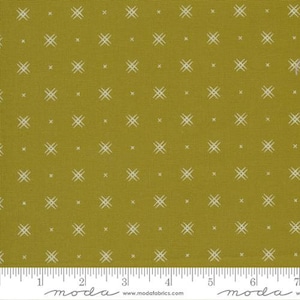 May include: A mustard yellow fabric with a white geometric pattern of small crosses. The fabric has a subtle texture.