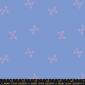 May include: A light blue fabric with a repeating pattern of pink butterflies. The fabric has a ruler printed at the bottom with the text "Ruby Star Society" repeated.