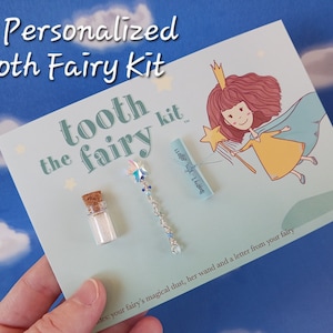 May include: A tooth fairy kit with a small bottle of glitter, a wand with a star on top, and a rolled up letter. The kit is on a light blue background with a cartoon tooth fairy.