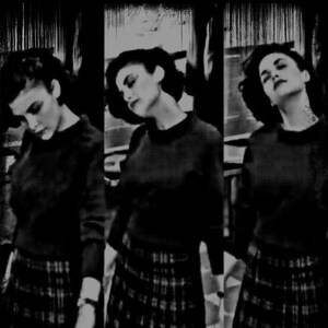 May include: Three women wearing black sweaters and plaid skirts. The women are standing in a row, and the image is cropped at the waist.