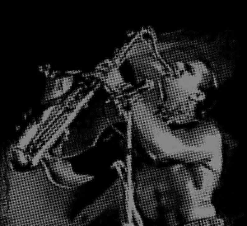 May include: A black and white photo of a person playing a saxophone. The person is shirtless and has their hair pulled back. The saxophone is held in a horizontal position.