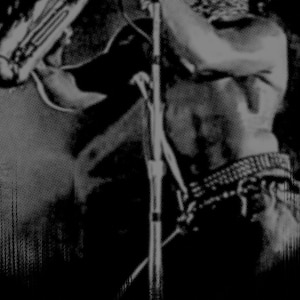 May include: A black and white photo of a person playing a musical instrument. The person is holding a microphone in their right hand and the instrument in their left hand. The person's face is partially obscured by the microphone.