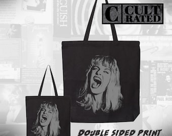 May include: Black tote bags featuring a grey image of a woman screaming. The bags have the text "DOUBLE SIDED PRINT" and "CULT RATED". The background features movie posters.