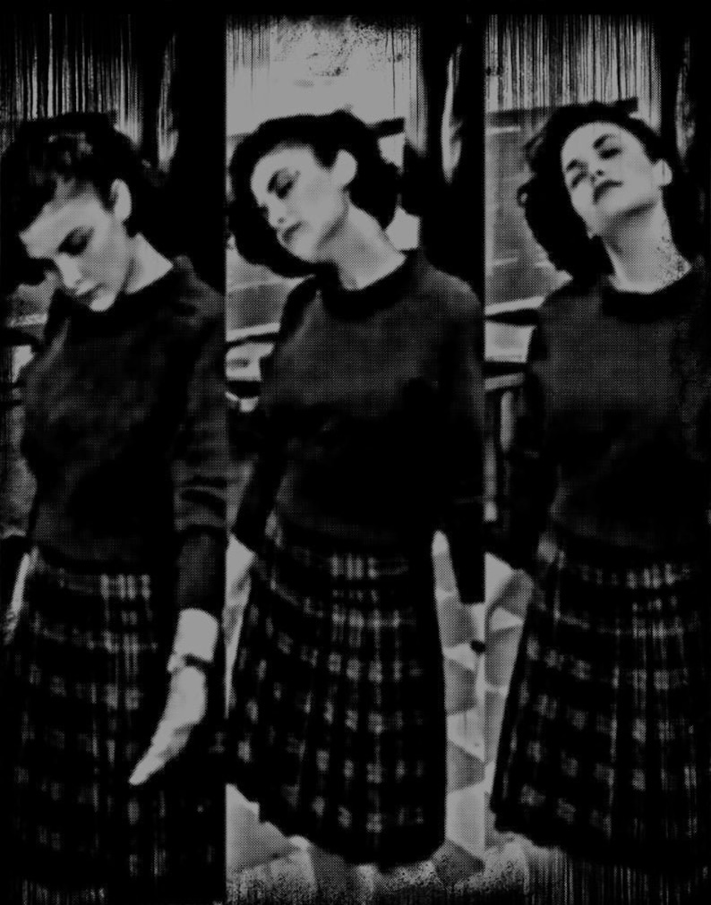 May include: Three women wearing black sweaters and plaid skirts. The women are standing in a row, and the image is cropped at the waist.