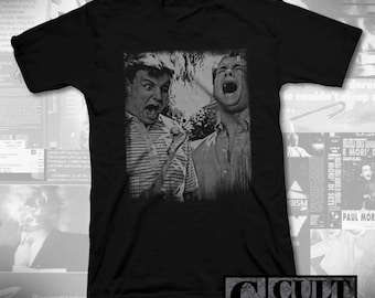 May include: Black V-neck t-shirt with a black and white film still of two men shouting. The image is in a square on the front of the shirt. The text "CULT RATED" is in the lower right corner.